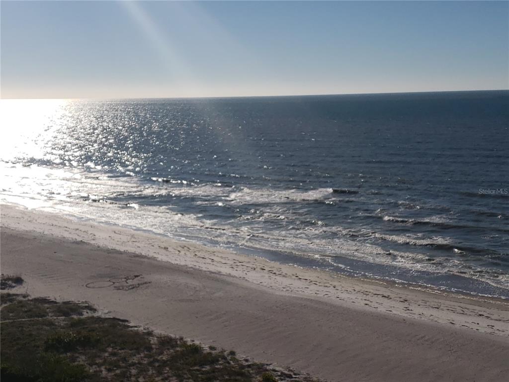 An elevated view of a sandy beach and the ocean under a clear sky — 1460 GULF BOULEVARD UNIT 1102, CLEARWATER, FL