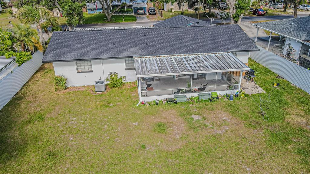An aerial view of a white house with a dark shingled roof and screened patio — 402 EUNICE DRIVE, PLANT CITY, FL