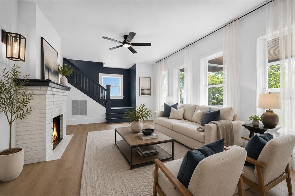 A covered front porch features a wooden swing, a dark front door, and tiled flooring — 6566 1ST AVENUE S, ST PETERSBURG, FL