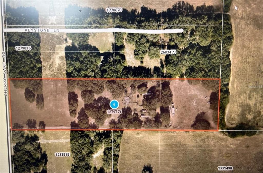 An aerial rendering shows a rectangular 10-acre RV storage lot with gravel rows and a building — 38020 CHERRY LAKE ROAD, FRUITLAND PARK, FL