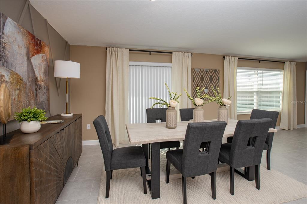 A dining room features a wooden table, six gray chairs, and a sideboard — 5162 WORCHESTER DRIVE, KISSIMMEE, FL