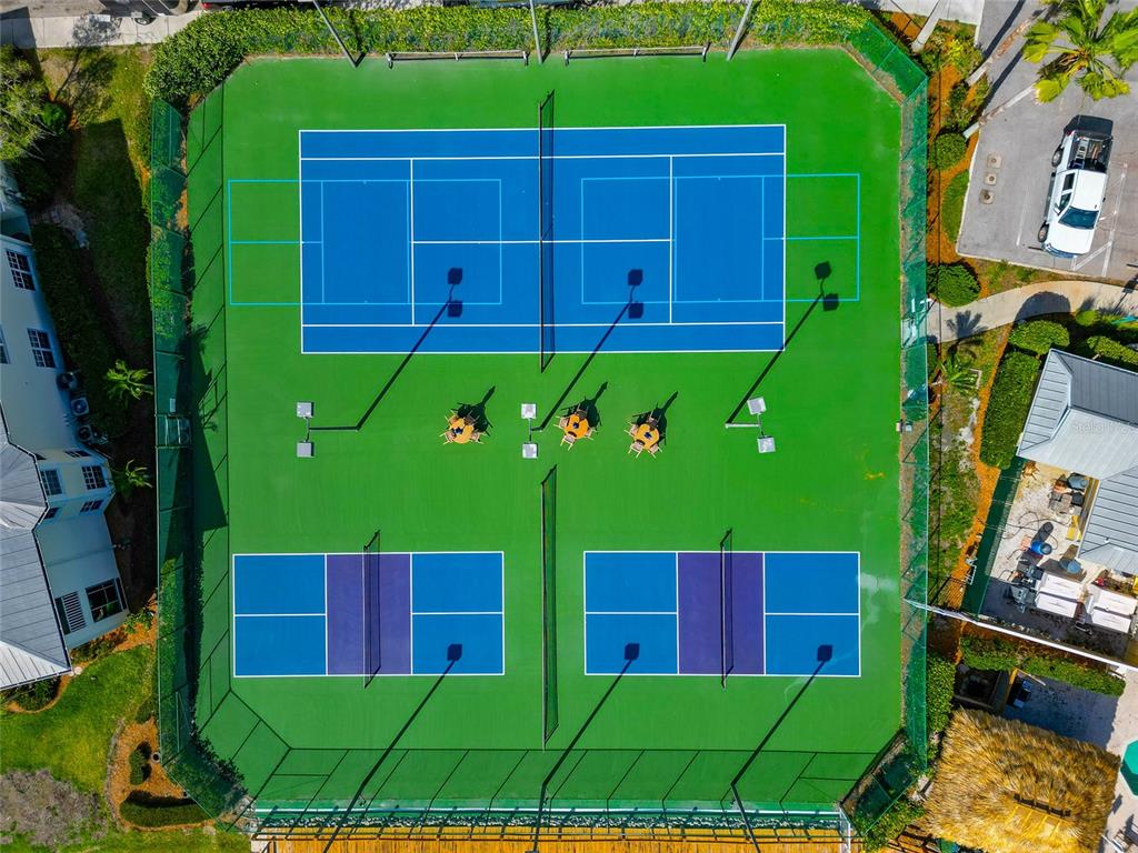 An aerial view shows a tennis court and two pickleball courts with surrounding fencing — 242 HIDDEN BAY DRIVE UNIT 602, OSPREY, FL