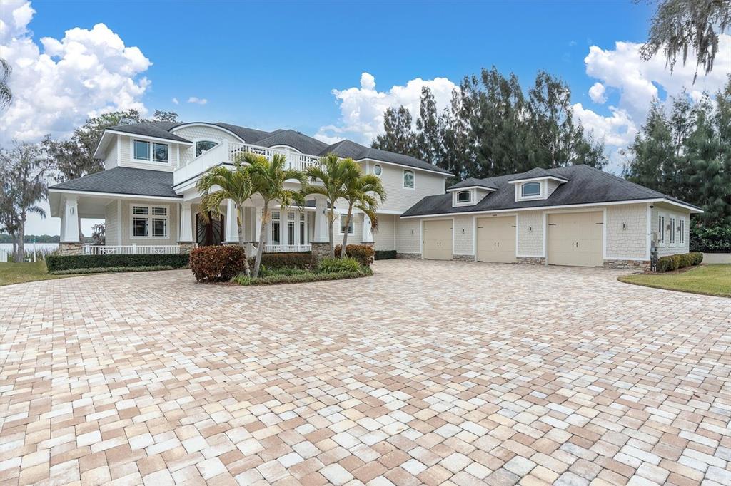 A large two-story house with a three-car garage and a paved driveway — 4650 RIDGE VIEW ROAD, PALM HARBOR, FL