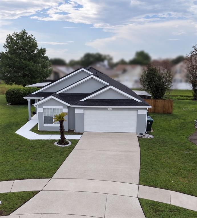 An aerial view of a gray single-story house with a black roof and solar panels — 4702 FORT BRAVO COURT, ORLANDO, FL