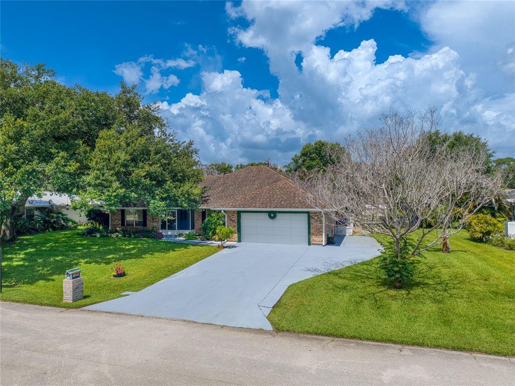 A single-story brick house with a two-car garage and a large front lawn — 465 11TH AVENUE, VERO BEACH, FL