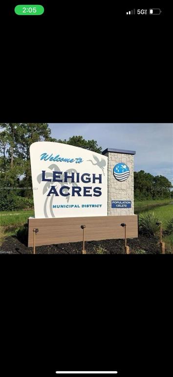 A sign welcomes visitors to the Lehigh Acres municipal district with a population count displayed — 715 DEVON STREET, LEHIGH ACRES, FL
