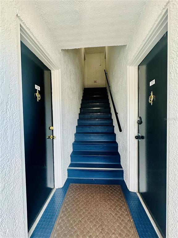 A black door with a keypad lock and the number 108 is set in a white wall — 525 CONWAY ROAD UNIT 108, ORLANDO, FL