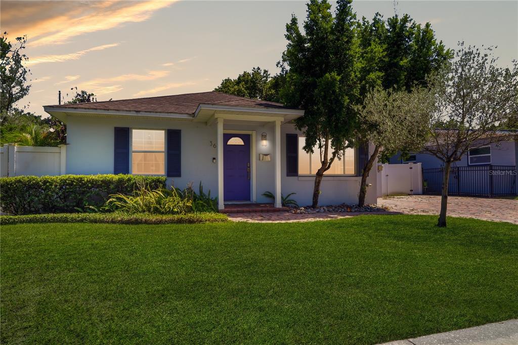A single-story house with a purple front door, white siding, and a green lawn — 36 E WINTER PARK STREETS, ORLANDO, FL