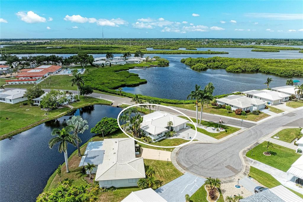 An aerial view shows a white house with a tiled roof located on a cul-de-sac — 4006 JOYCE DRIVE, BRADENTON, FL