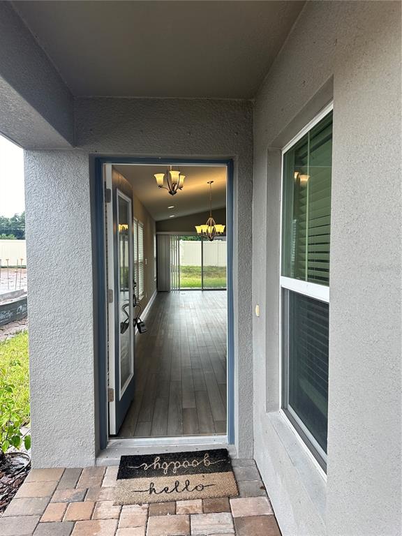 A view from a paved entryway through an open door into a home interior — 12533 OAK HILL WAY, PARRISH, FL