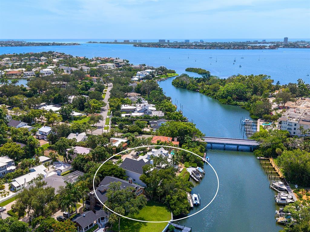 An aerial view shows a waterfront house with a private dock and boat lift — 1621 BAY POINT COURT, SARASOTA, FL