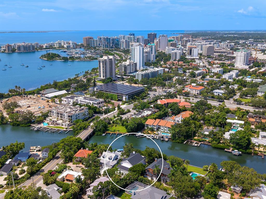 An aerial view shows a waterfront house circled in a residential neighborhood near a bay — 1621 BAY POINT COURT, SARASOTA, FL