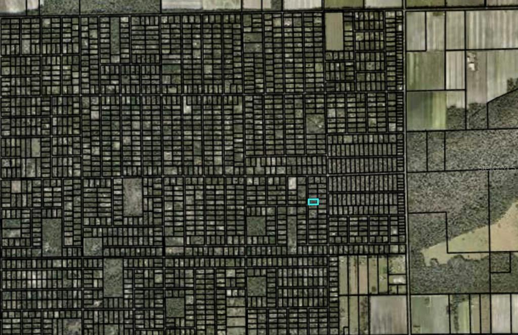This is an aerial map showing a grid of land parcels with one highlighted lot — 2157 GROVE STREET, BUNNELL, FL