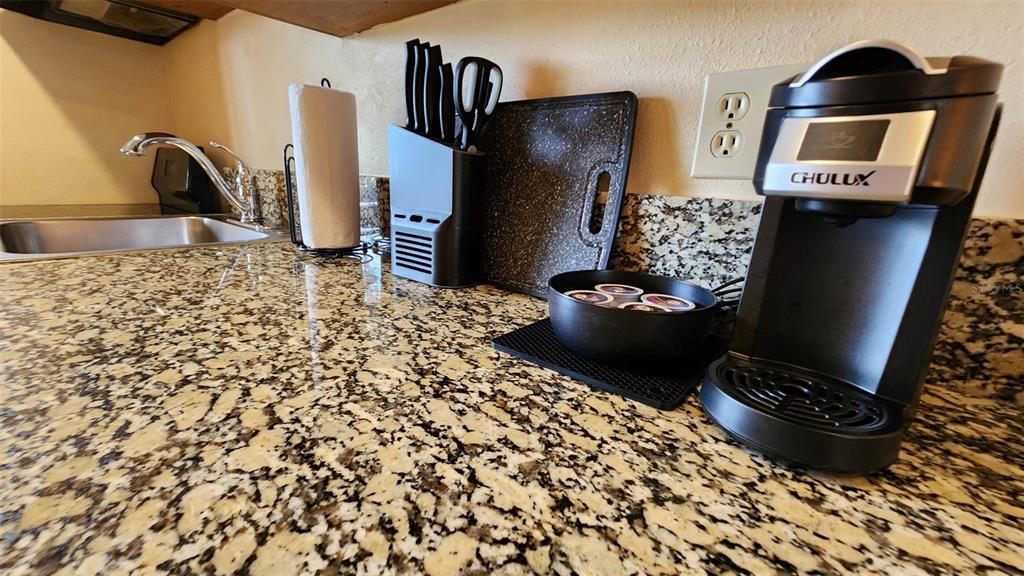 A kitchen counter features a coffee maker, a knife block, and a sink — 3200 RIVER RANCH BOULEVARD UNIT 151, RIVER RANCH, FL
