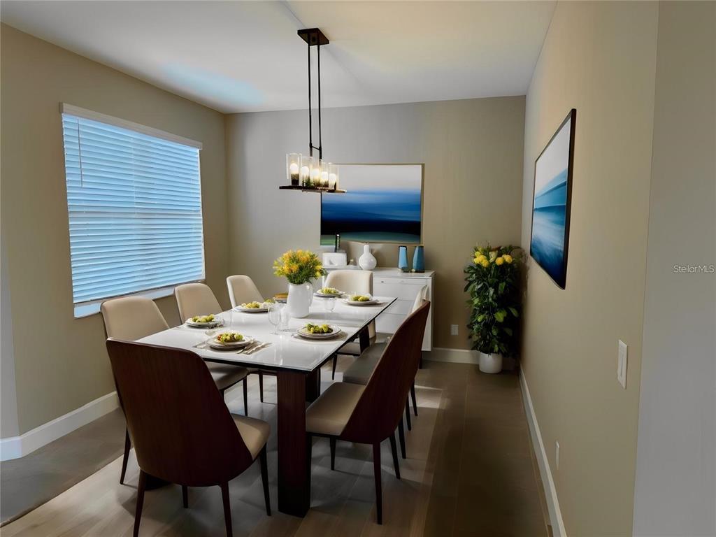 A dining room features a rectangular table, six chairs, a modern light fixture, and artwork — 4950 SIENNA ISLES AVENUE, WIMAUMA, FL