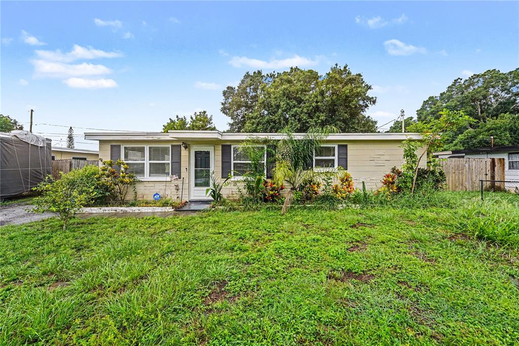 A single-story house with light-colored siding, a front door, and a grassy yard — 8490 92ND TER, SEMINOLE, FL