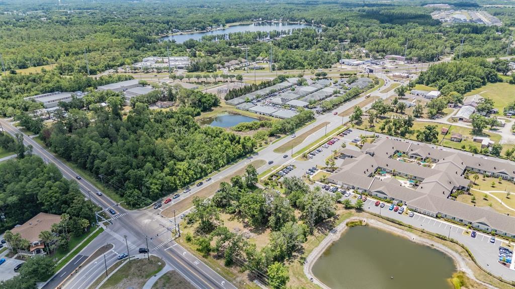 Aerial view of a suburban area featuring a large complex, ponds, and surrounding roads — 18950 SUNLAKE BOULEVARD, LUTZ, FL