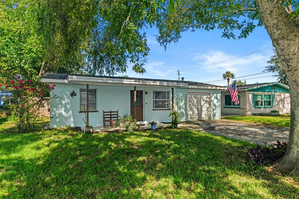 A single-story light blue house with a front porch, garage, and a grassy lawn — 2608 ANASTASIA DRIVE, SOUTH DAYTONA, FL