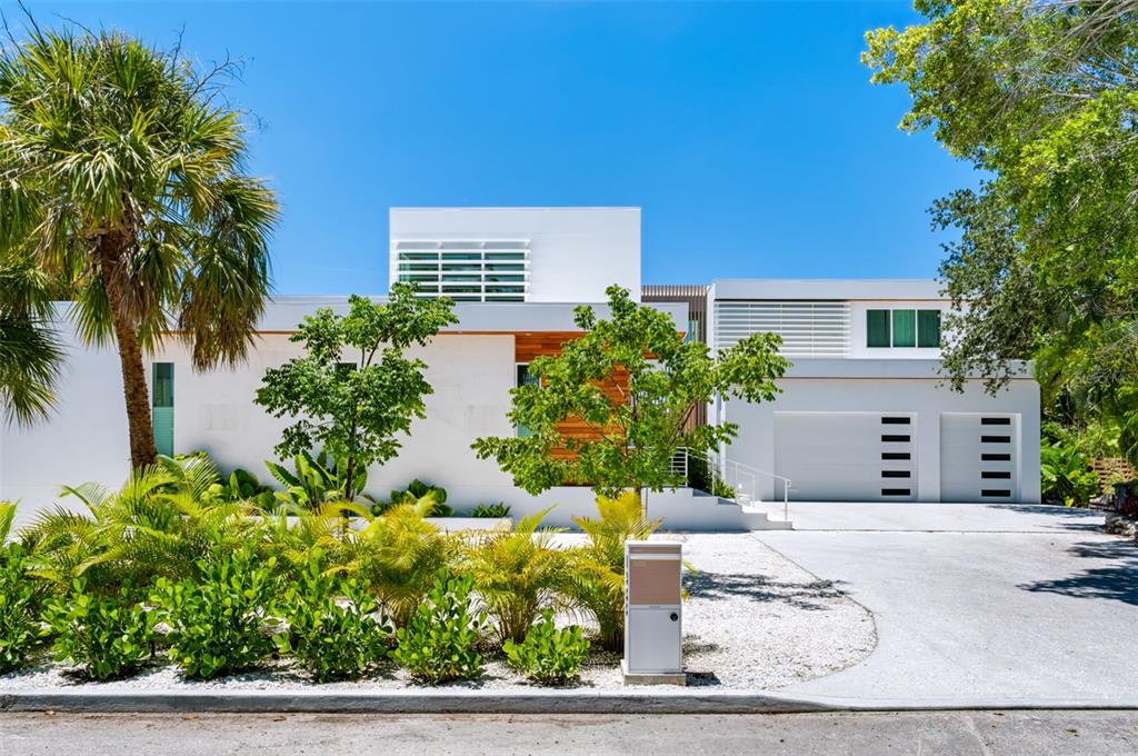 A modern white two-story house with a two-car garage and landscaped front yard — 1355 ROBERTS BAY LANE, SARASOTA, FL