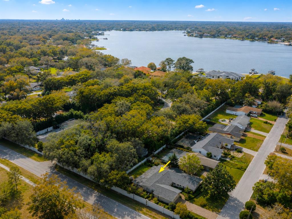 An aerial view shows a residential house with a yellow arrow pointing to its roof — 2102 W KYRA DRIVE, TAMPA, FL