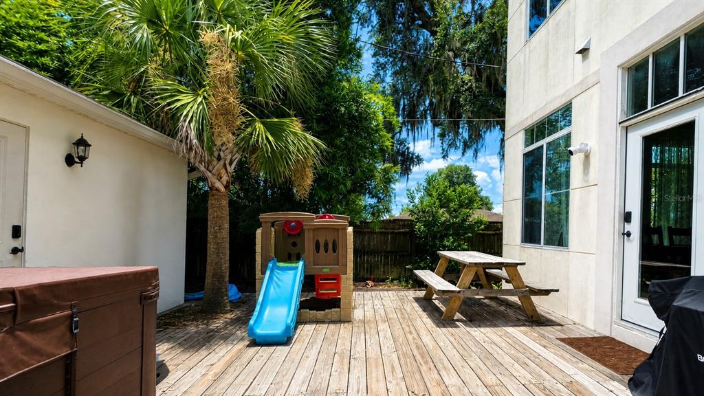 A dark front door with a transom window sits between two stone pillars — 759 LAKE BALDWIN LANE, ORLANDO, FL