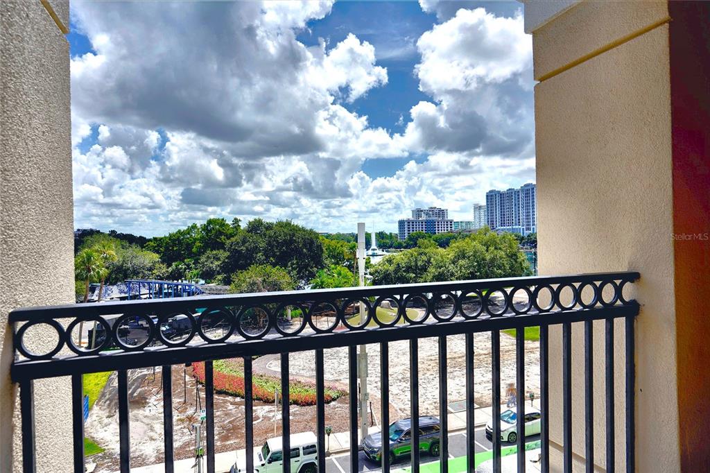 A modern lobby features a staircase, textured accent walls, and large light-colored floor tiles — 151 E WASHINGTON STREET UNIT 525, ORLANDO, FL