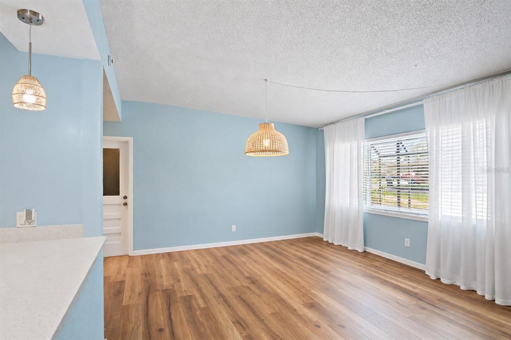 A dining area with a wooden hutch and a pass-through window to the kitchen — 1840 N POWERS DRIVE, ORLANDO, FL