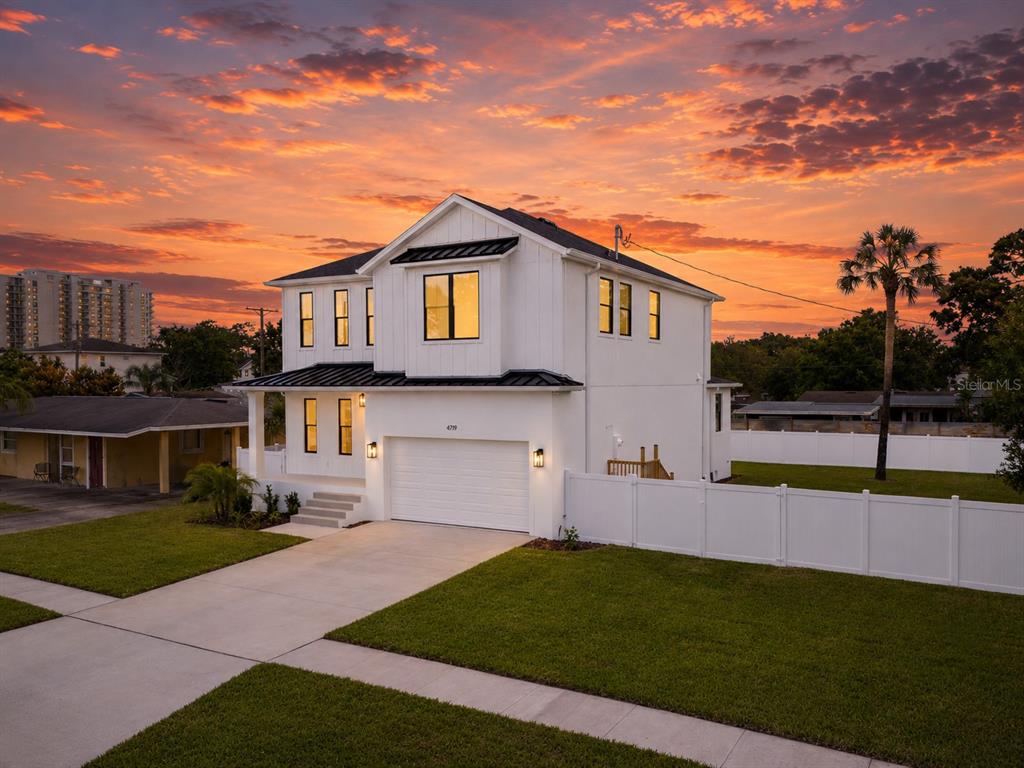 A bright hallway features light wood flooring, white walls, and a glass-paneled door — 4719 W WYOMING AVENUE, TAMPA, FL