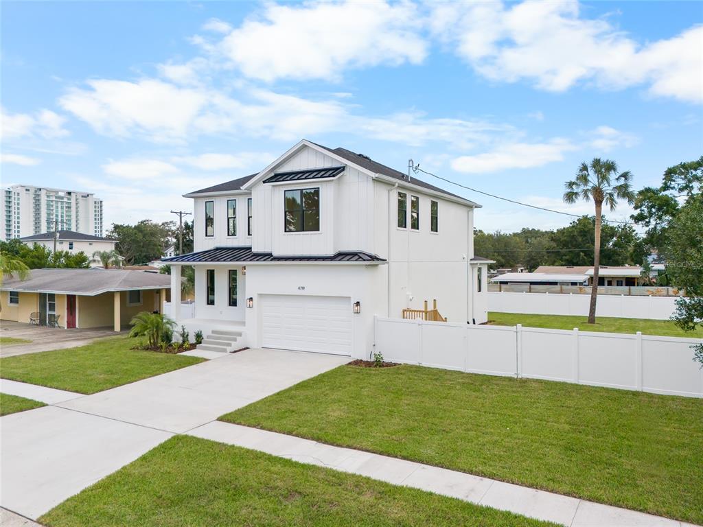 A room with light wood floors, white walls, and a dark green accent wall — 4719 W WYOMING AVENUE, TAMPA, FL