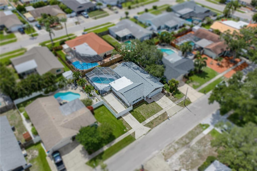 An aerial view shows a house with a screened-in pool and a two-car driveway — 9305 120TH LANE, SEMINOLE, FL