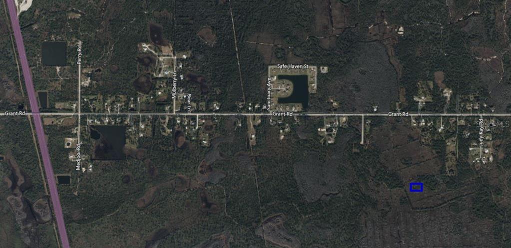 This is an aerial map showing a small rectangular property highlighted in blue near Grant Road — NO NAME, GRANT, FL