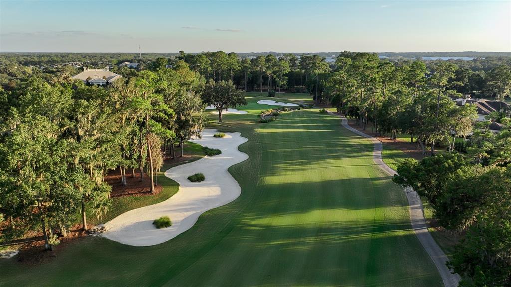 An aerial view of a golf course fairway lined with trees and sand bunkers — NW 31ST LANE ROAD, OCALA, FL