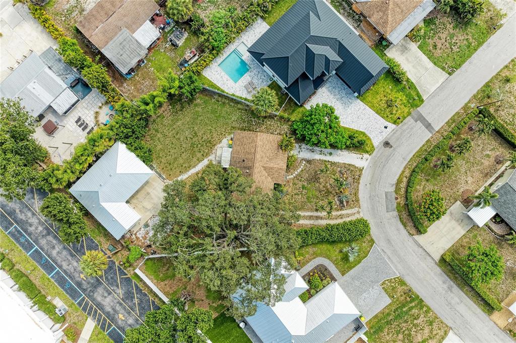 An aerial view shows two houses with a grassy yard and mature trees between them — 1300 LOMA LINDA COURT, SARASOTA, FL