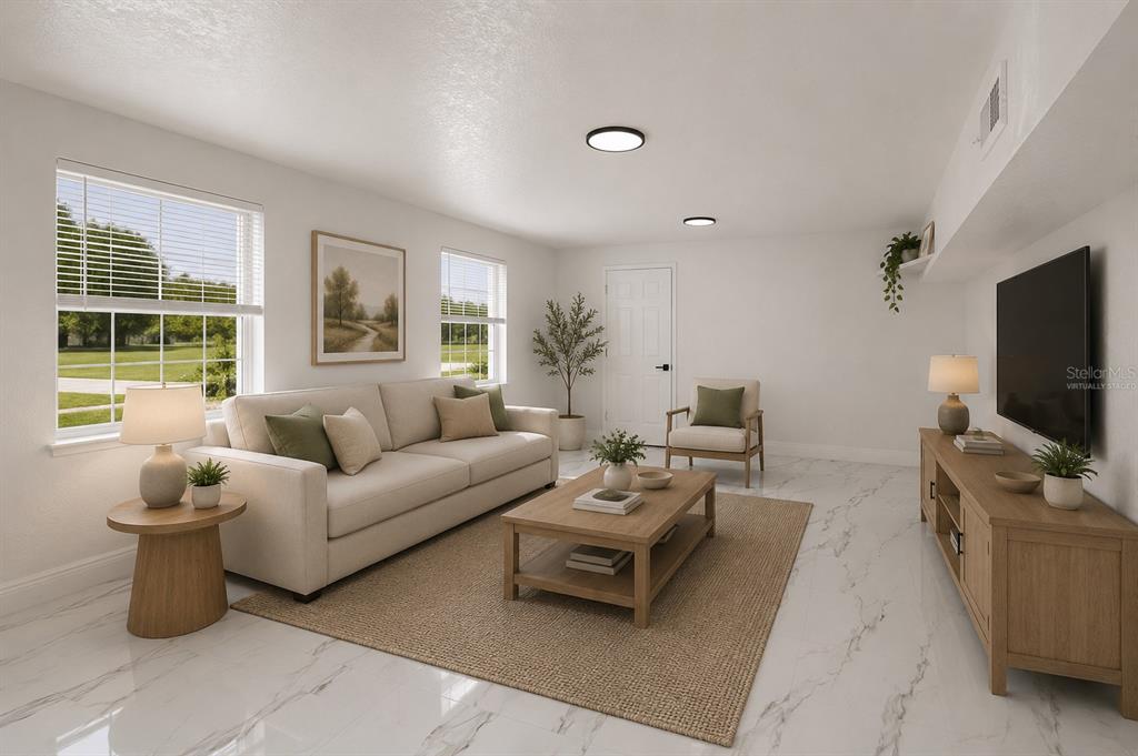 This virtually staged living room features white walls, marble-look tile flooring, and a neutral sofa — 1602 S TANNER ROAD, ORLANDO, FL