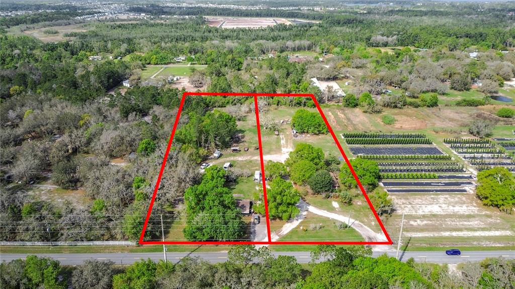 An aerial view shows two adjacent rectangular lots with trees and structures along a road — 2360 ABSHER ROAD, ST CLOUD, FL