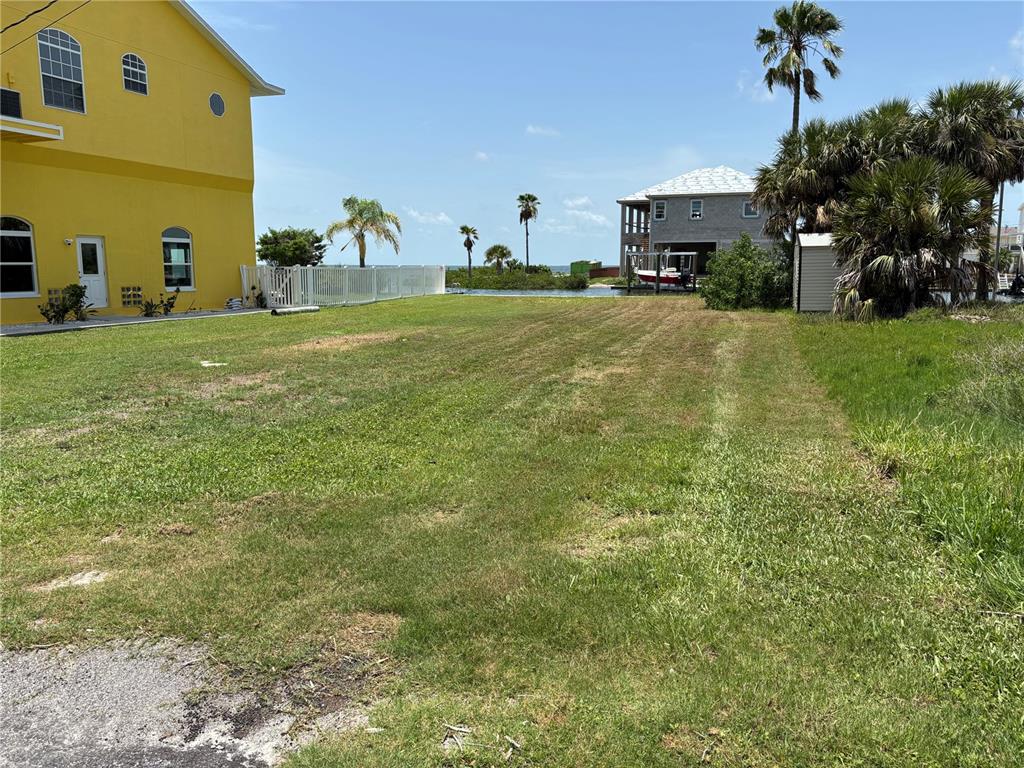 A vacant grassy lot sits between a yellow house and a waterfront property — 0 SEAVIEW BOULEVARD, HUDSON, FL