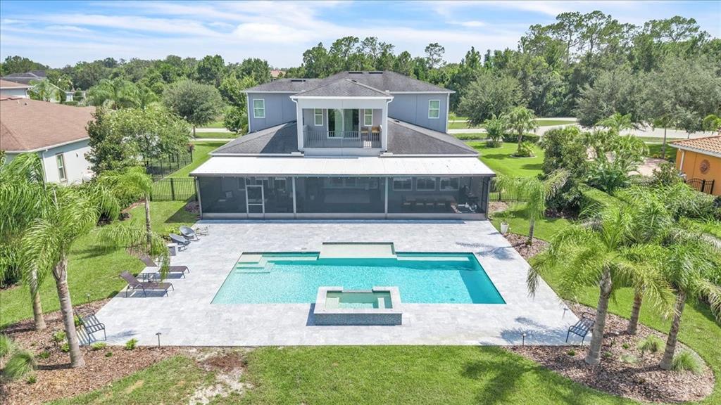 An aerial view of a two-story house with a screened-in patio and a swimming pool — 17923 BARN CLOSE DRIVE, LUTZ, FL