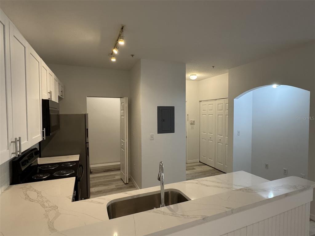 A kitchen features white cabinets, a marble-look countertop, a stainless steel sink, and stainless appliances — 540 FLORIDA CLUB BOULEVARD UNIT 305, ST AUGUSTINE, FL