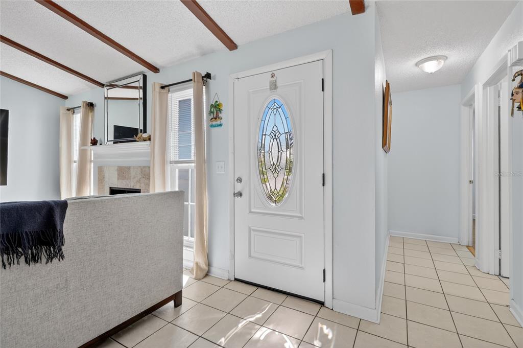 An entryway features a white front door with an oval glass insert and tiled flooring — 4646 OLD 37 ROAD, LAKELAND, FL