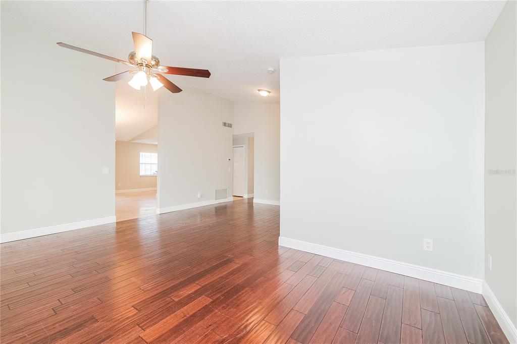 An interior view of a room with dark wood flooring, light walls, and a ceiling fan — 1535 LAWNDALE CIRCLE, WINTER PARK, FL