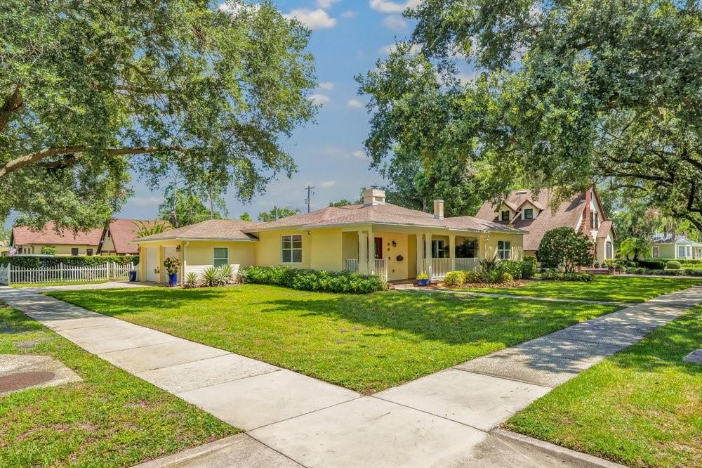 A yellow single-story house with a front porch and attached garage sits on a lawn — 601 WESTMINSTER STREET, ORLANDO, FL