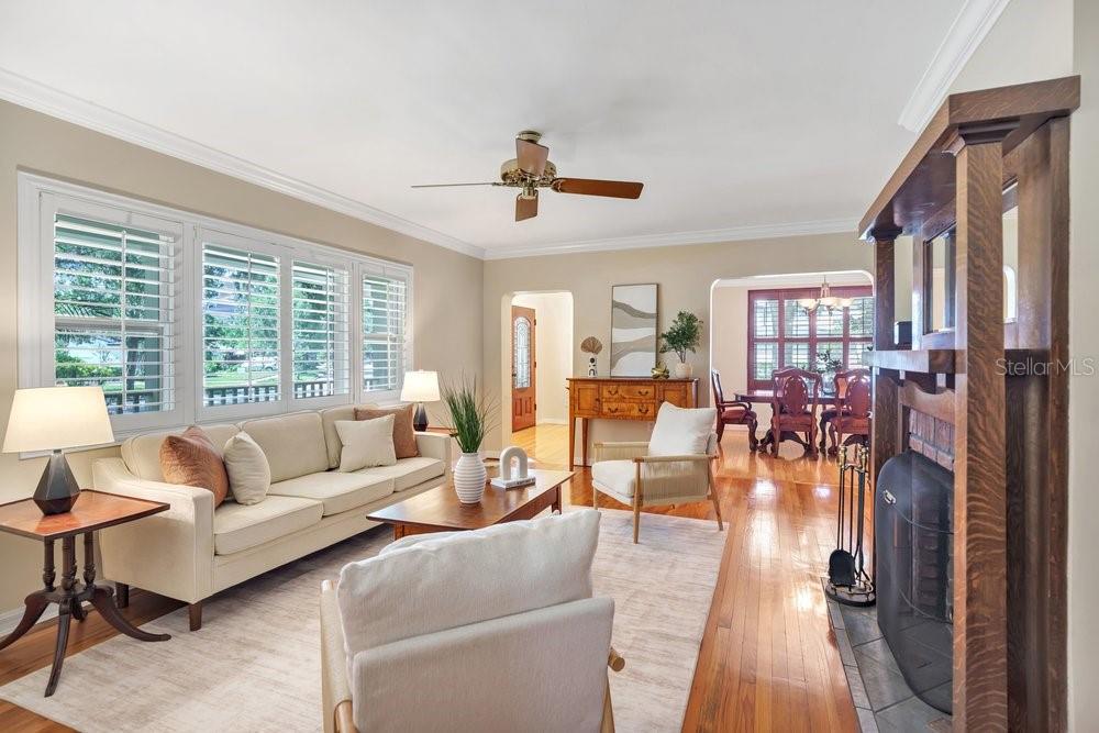 A living room with hardwood floors, a brick fireplace, and a sofa facing a coffee table — 601 WESTMINSTER STREET, ORLANDO, FL