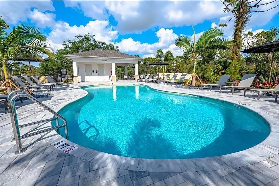 A carpeted staircase leads upward to a landing with a white double-door closet — 7154 GRAND FOREST WAY, NOKOMIS, FL