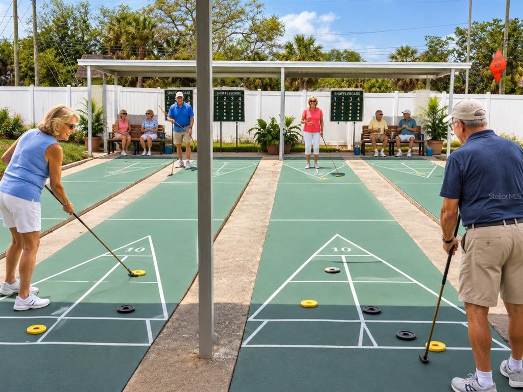 A green outdoor tennis court with a net and a surrounding chain-link fence — 1250 S PINELLAS AVENUE UNIT 804, TARPON SPRINGS, FL