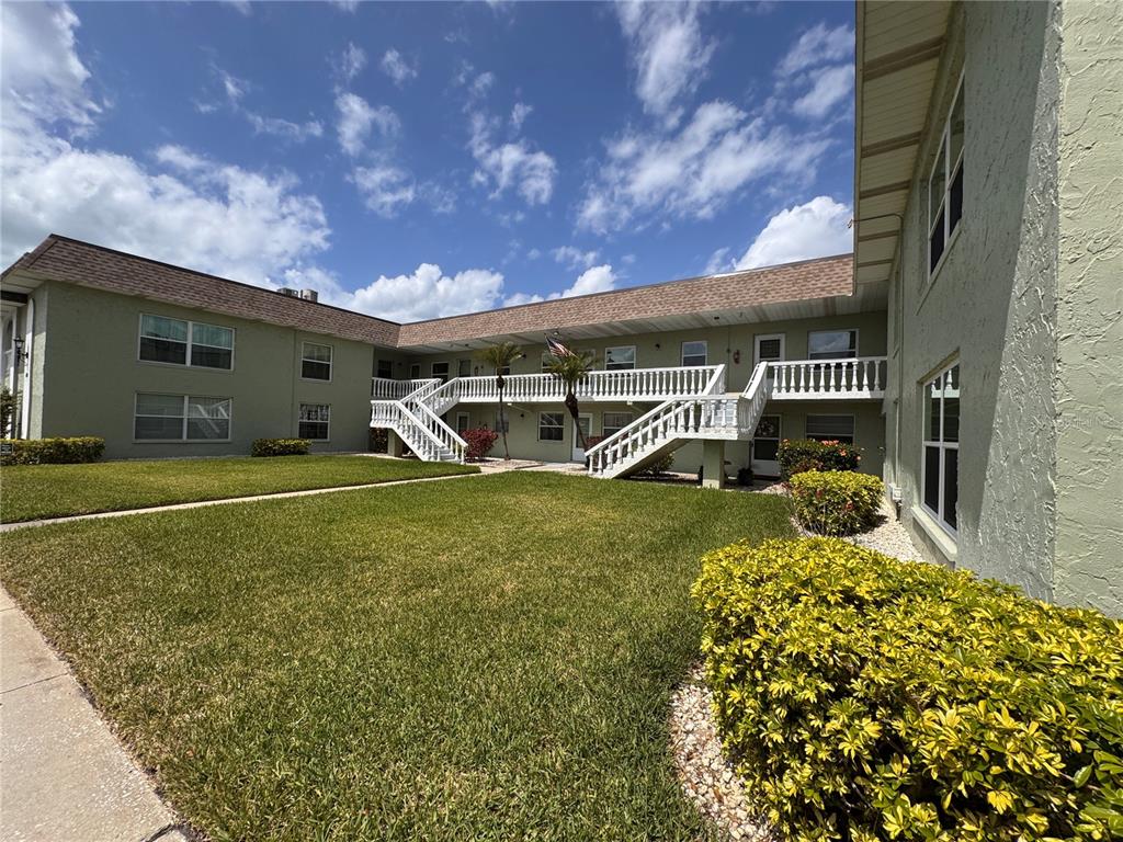 Two outdoor shuffleboard courts are situated under a covered pavilion with benches and scoreboards — 1250 S PINELLAS AVENUE UNIT 804, TARPON SPRINGS, FL