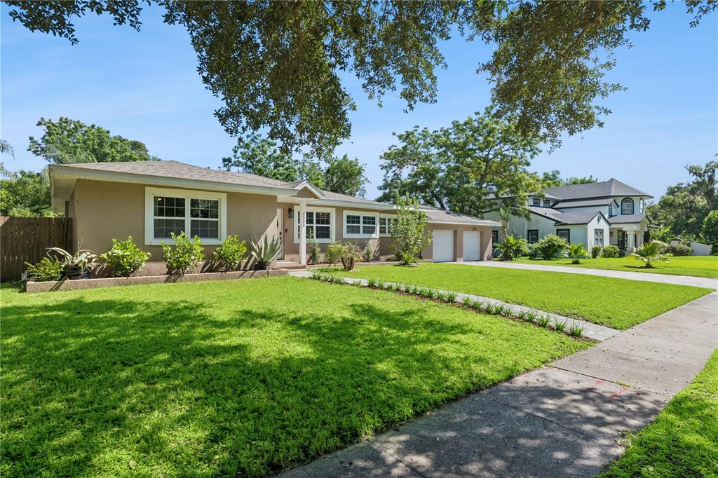 A single-story tan house with a two-car garage and a large front lawn — 2333 WESTMINSTER COURT, WINTER PARK, FL