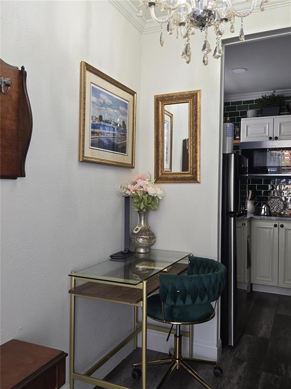 A small desk with a glass top and green velvet chair sits near a kitchen — 1690 S 10TH STREET UNIT A, HAINES CITY, FL