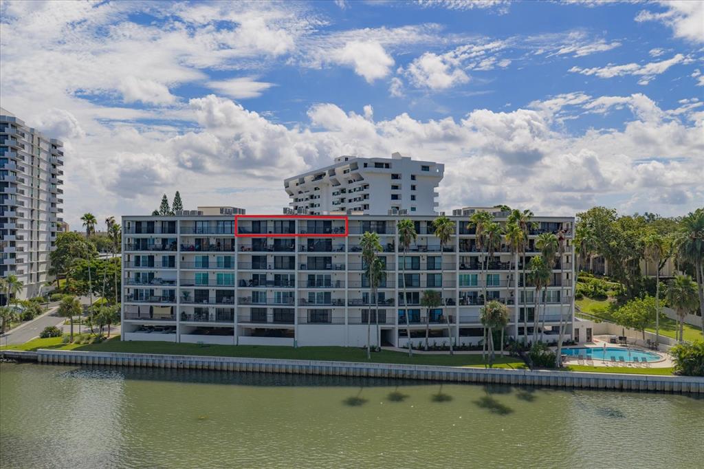 An exterior view of a multi-story waterfront condominium building with a red-outlined balcony — 55 ROGERS STREET UNIT P3, CLEARWATER, FL