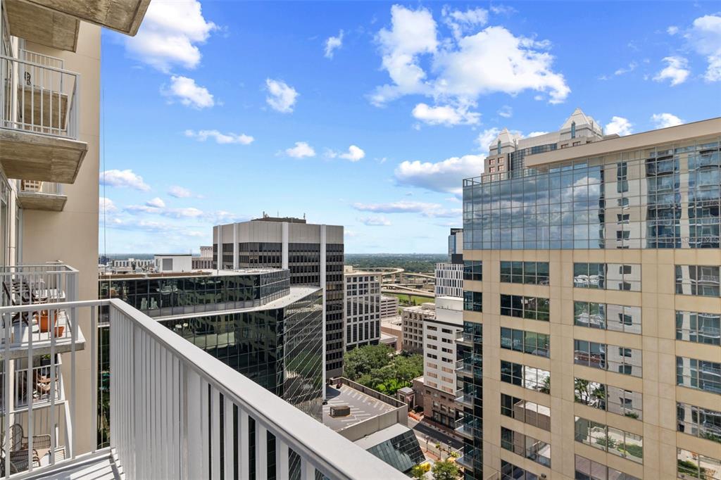 A kitchen island with granite countertops sits in a room featuring floor-to-ceiling windows and views — 155 S COURT AVENUE UNIT 2008, ORLANDO, FL