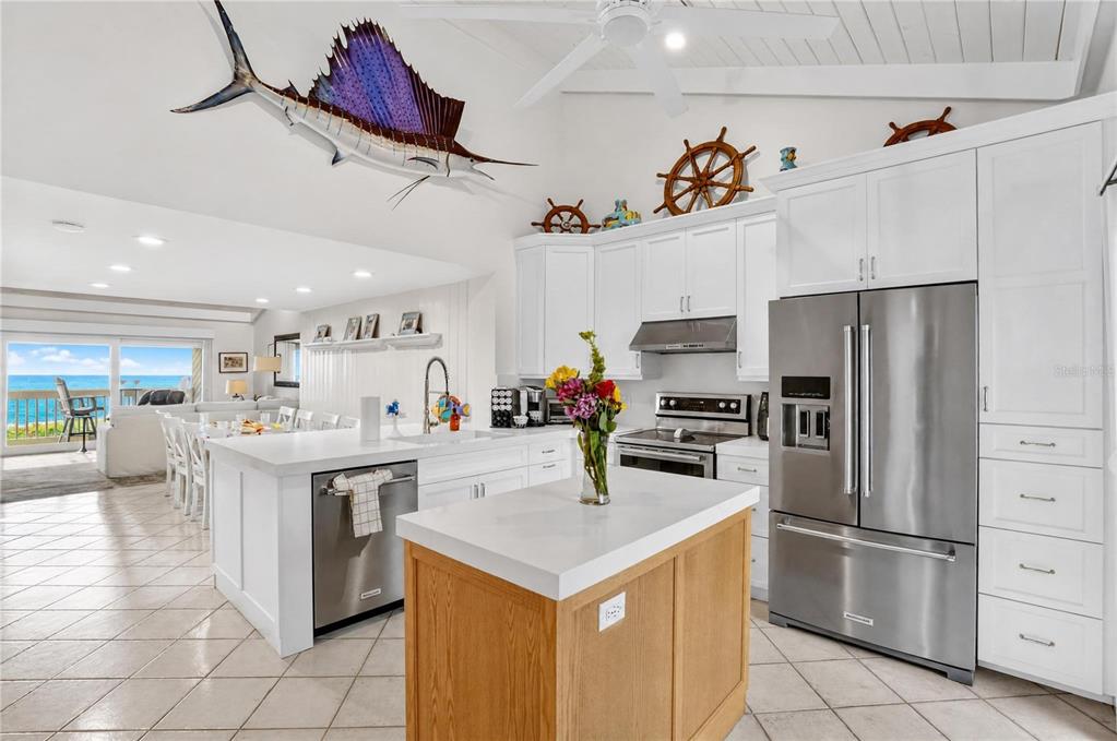 A kitchen with white cabinets, a wooden island, and a sailfish mount on the ceiling — 5275 GULF OF MEXICO DRIVE UNIT 202, LONGBOAT KEY, FL